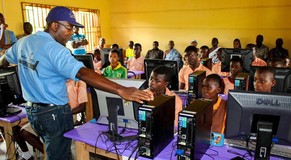 SustainLife Foundation IT trainer leading a hands-on computer skills session for students in Tanzania